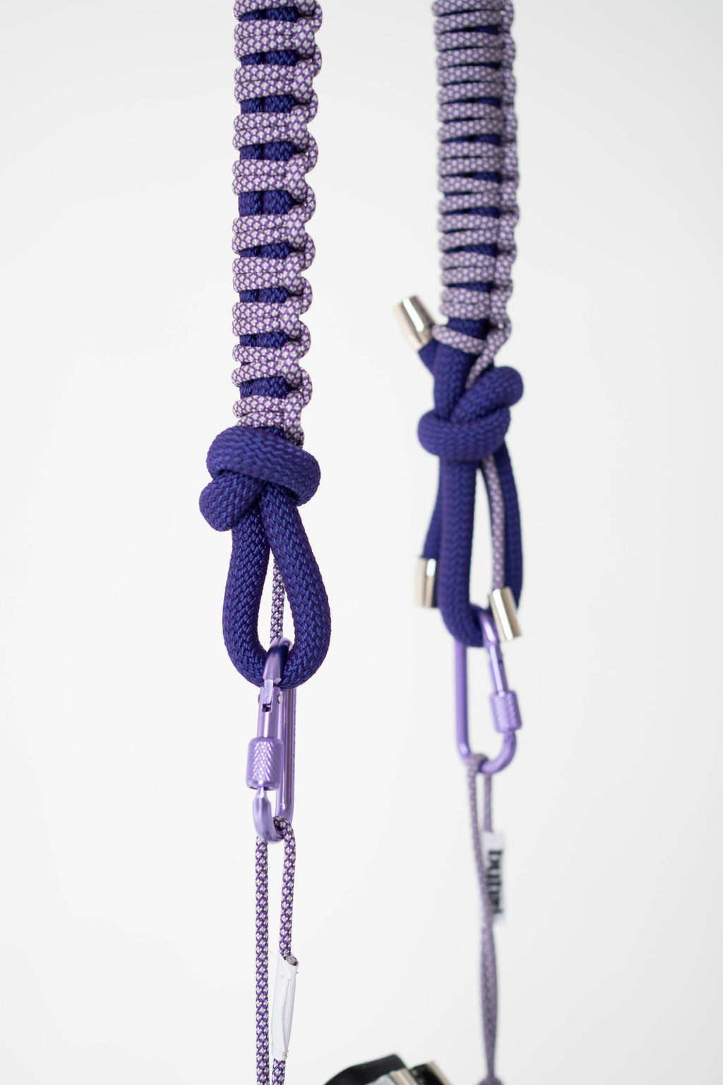 Front view of a model wearing the purple Bubzi camera strap with a camera
