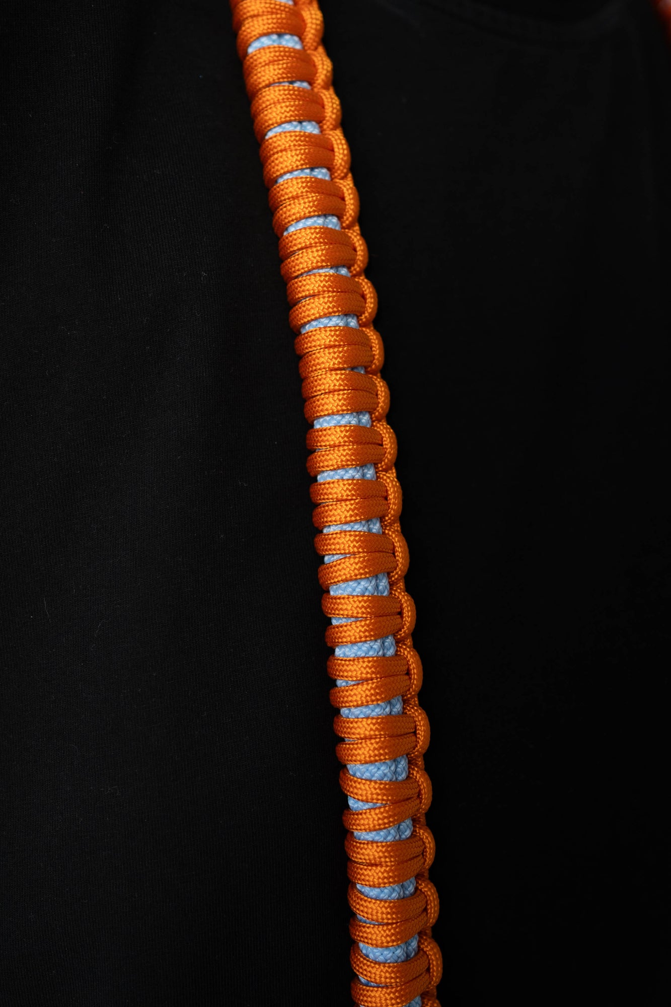 Close-up of the orange and blue paracord weave on the Bubzi camera strap