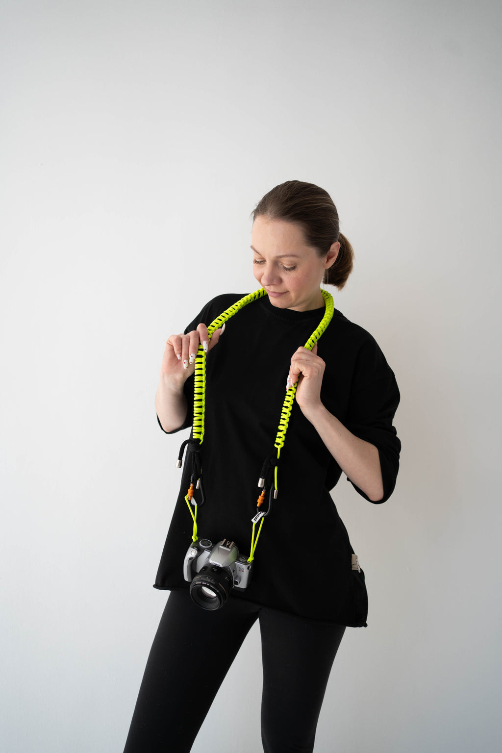Black and lime Bubzi camera strap styled as a bright accessory for everyday photo shoots