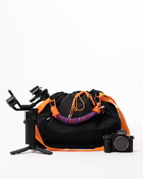 Black Maxi Bubzi bag next to a camera and stabilizer for photo and video shoots