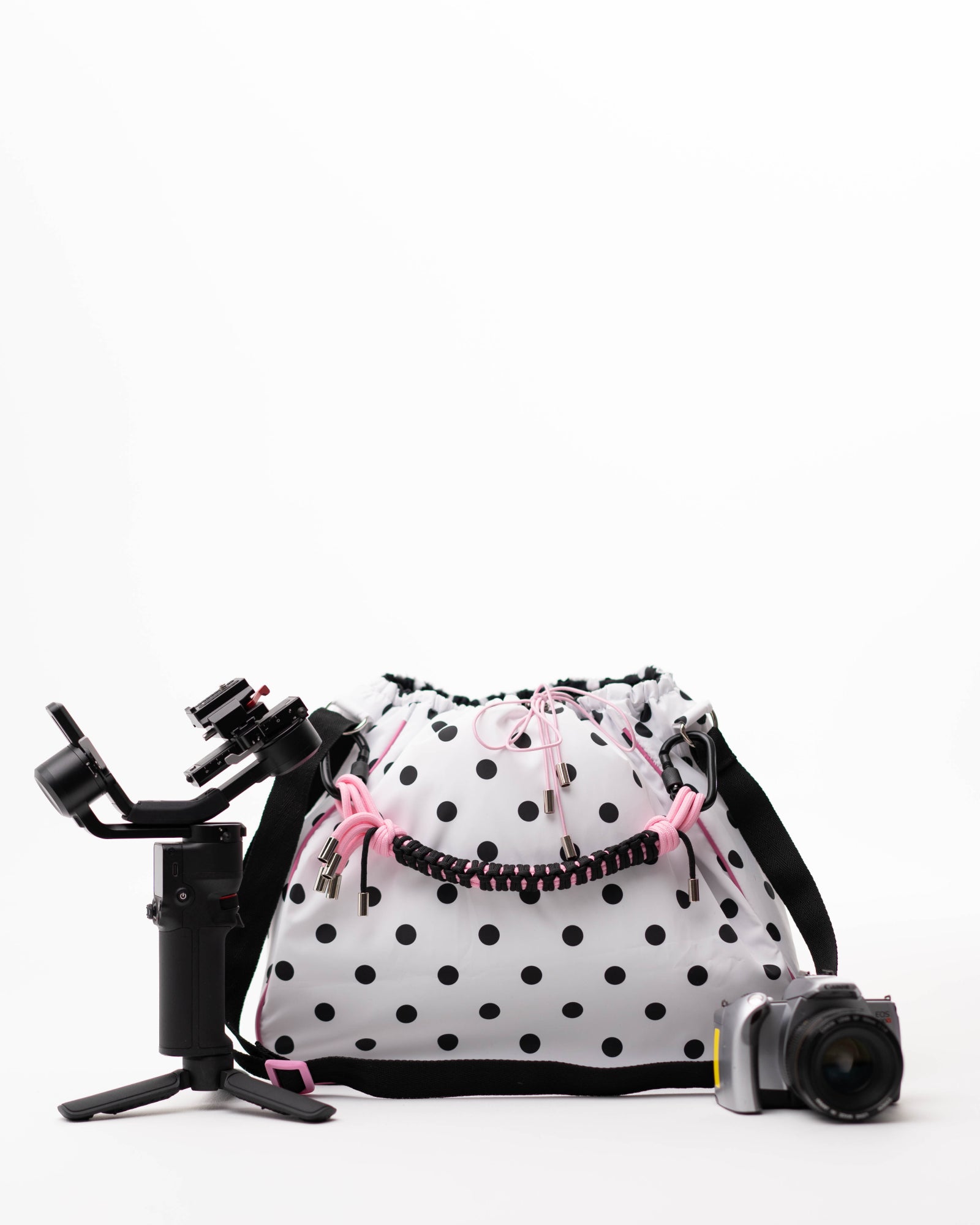 Polka dot Maxi Bubzi bag next to a camera and a stabilizer for filming.