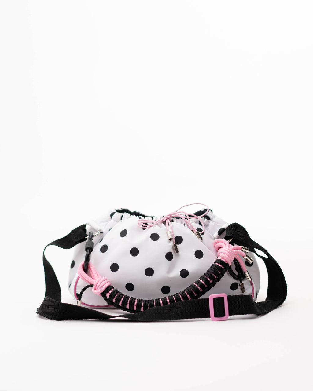 Polka dot Mini Bubzi bag with pink drawstrings, black shoulder strap, and braided paracord handle