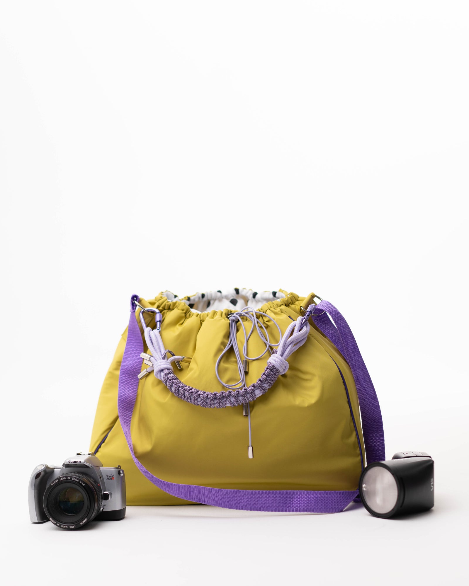 Lime Maxi Bubzi bag in side view with a soft shape and purple details.