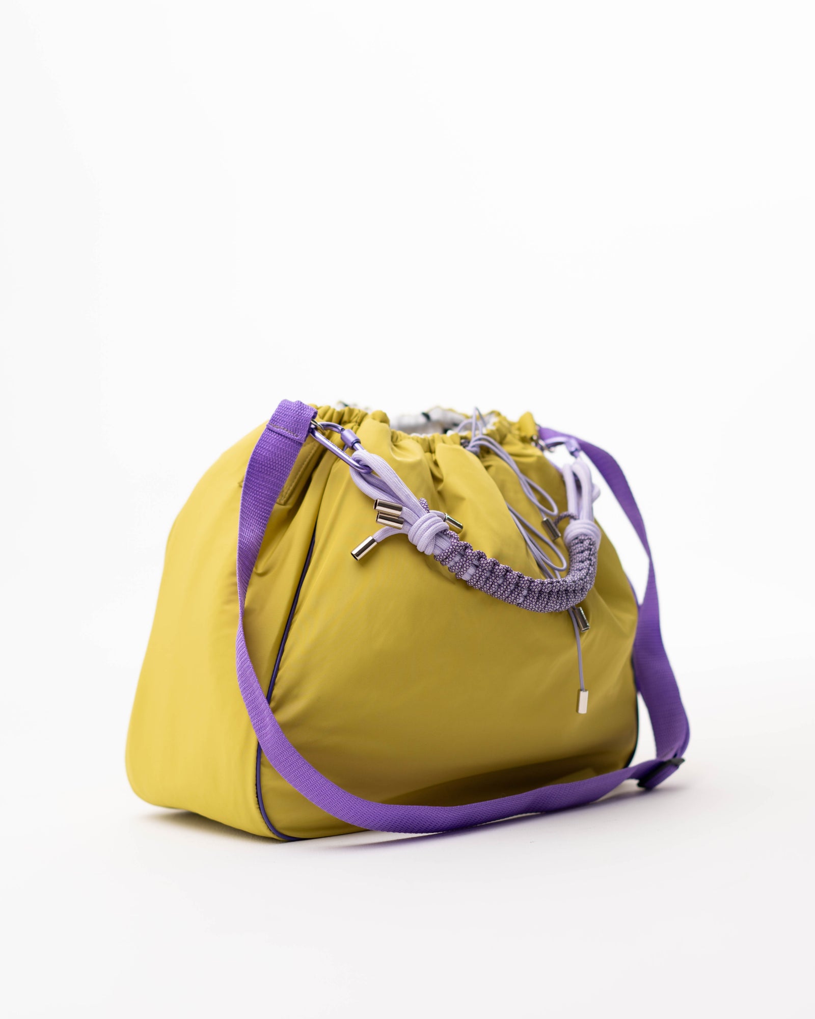 Lime Maxi Bubzi bag with a purple strap, braided handle, and drawstring.