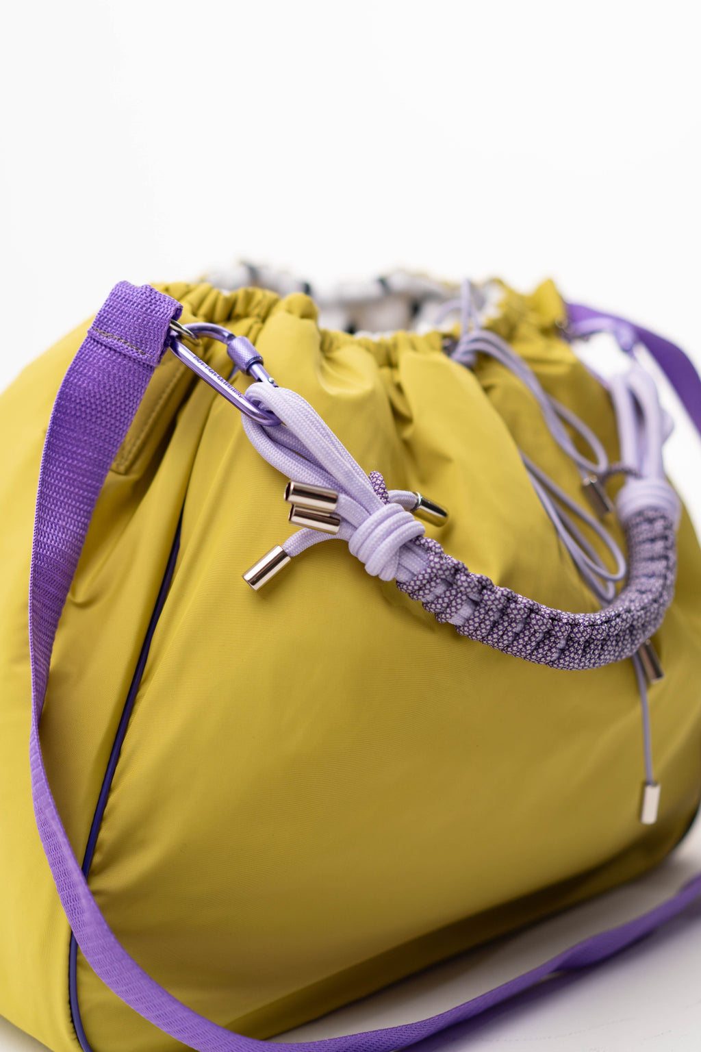 Close-up of the braided handle, drawstring, and fabric of the lime Maxi Bubzi bag.