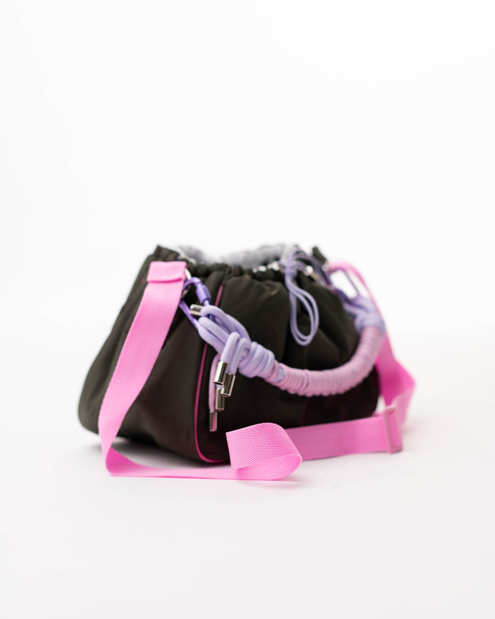 Side view of the khaki Mini Bubzi bag with pink shoulder strap and compact rounded shape