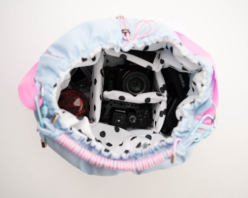 Light blue Maxi Bubzi bag with soft compartments for a camera, lenses, and photography equipment.