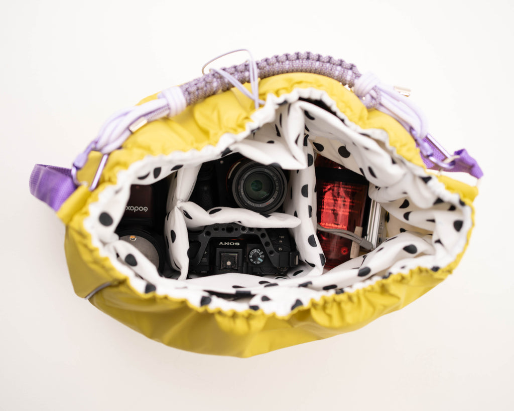 Lime Maxi Bubzi bag with soft compartments for a camera, lenses, and accessories.