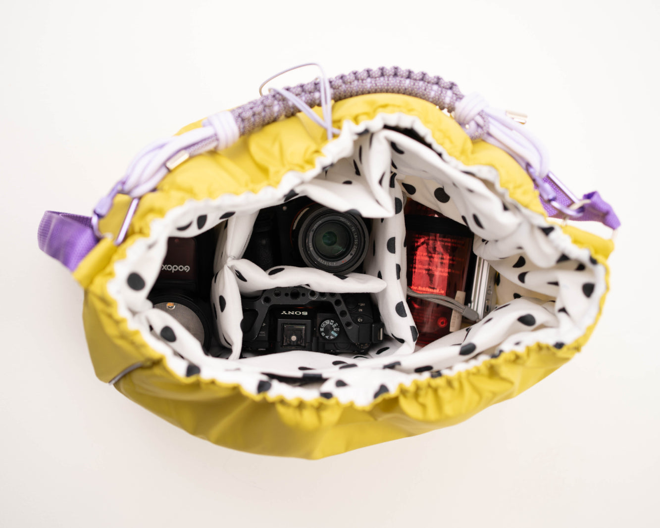 Lime Maxi Bubzi bag with soft compartments for a camera, lenses, and accessories.