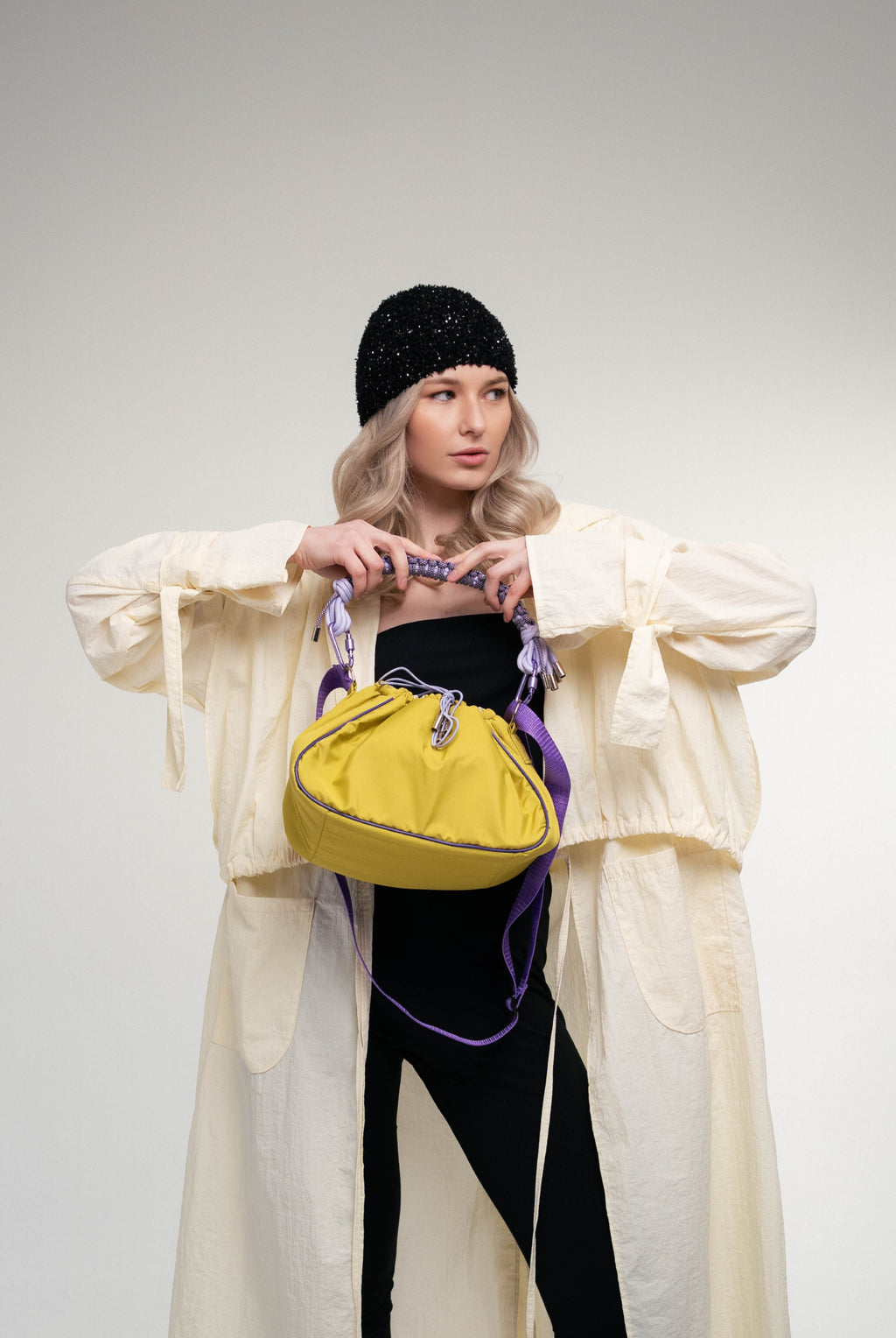 model posing with lime Mini Bubzi camera bag in a studio